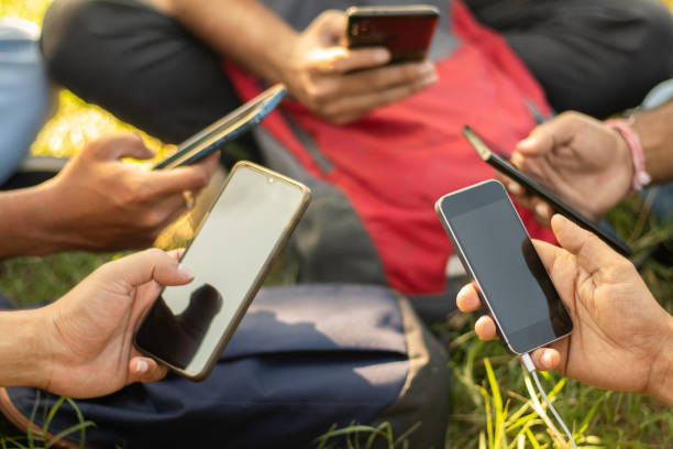 Close up of young people hands holding mobile - College Students addicted to smartphone - young millennials busy on cell phone - Group of friends sharing content on social media